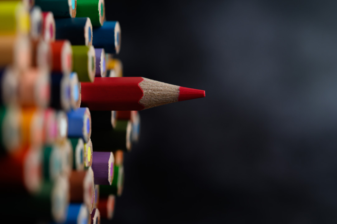 Closeup with a group of colored pencils, selected focus, red