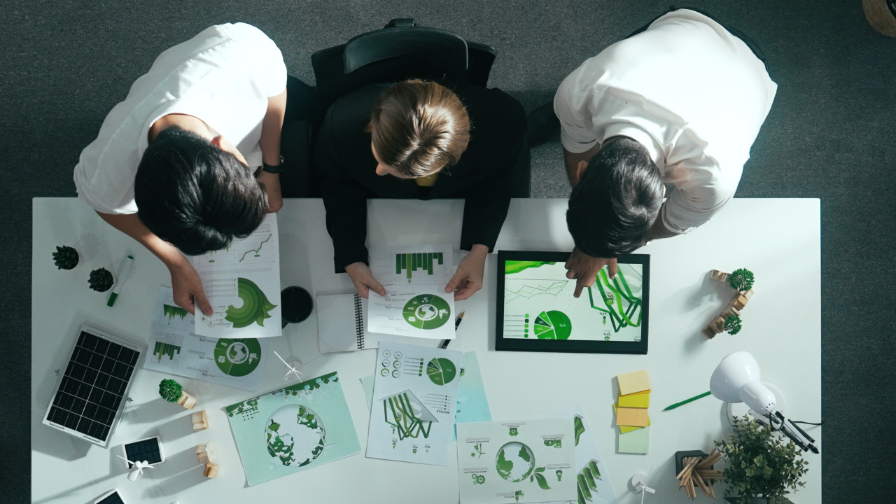 Top aerial view of businessman and manager talking about clean energy investment. Aerial view of business team working together planning to use renewable energy. ESG modern development. Alimentation.