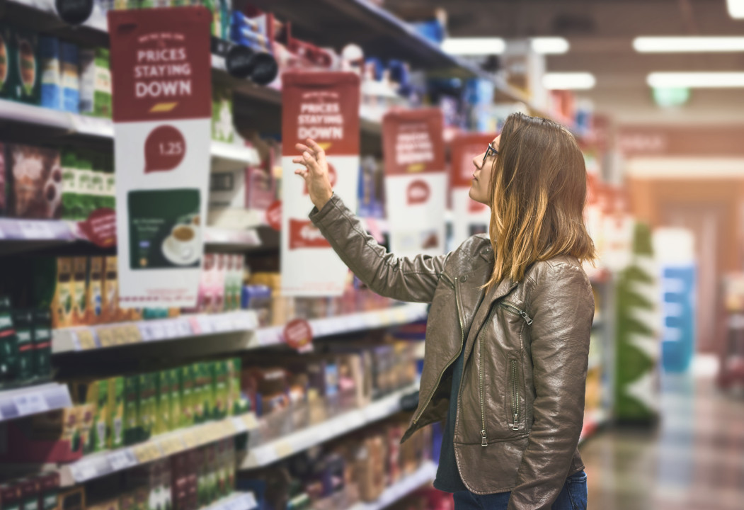Shopping, woman at grocery store and in aisle searching and decision for product on a shelf. Customer or consumer, shopper for groceries and female person at supermarket or a shop looking for food.